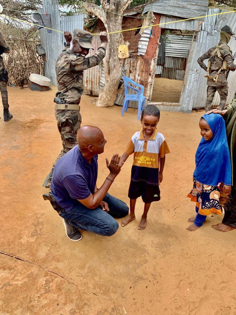 XIM Chair Abshir Ferro is greeted by children